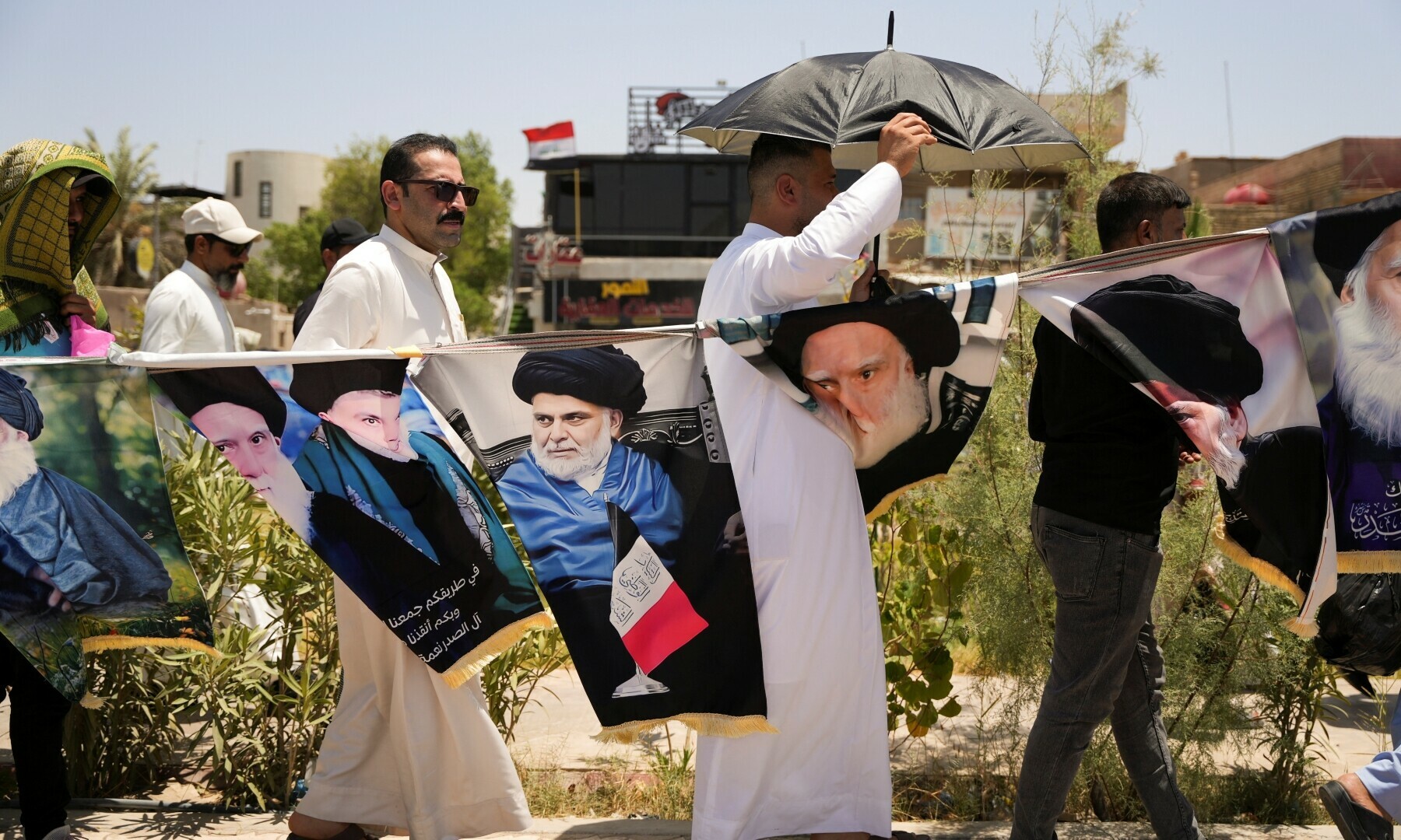  Supporters of Iraqi Shia cleric Moqtada al-Sadr walk past posters of Sadr and his father, the late Grand Ayatollah Mohammed Sadeq al-Sadr, during a protest following Friday prayers against repeated violations of Iraqi airspace, amid the Iran-Israel conflict, in Basra, Iraq on June 20, 2025. &mdash; Reuters/Essam Al-Sudani 