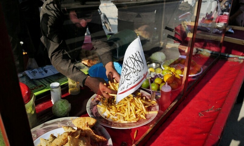 A Taliban flag of the Islamic Emirate of Afghanistan is attached on a food street cart at a market in Kabul, Afghanistan in October 2021. — Reuters/File