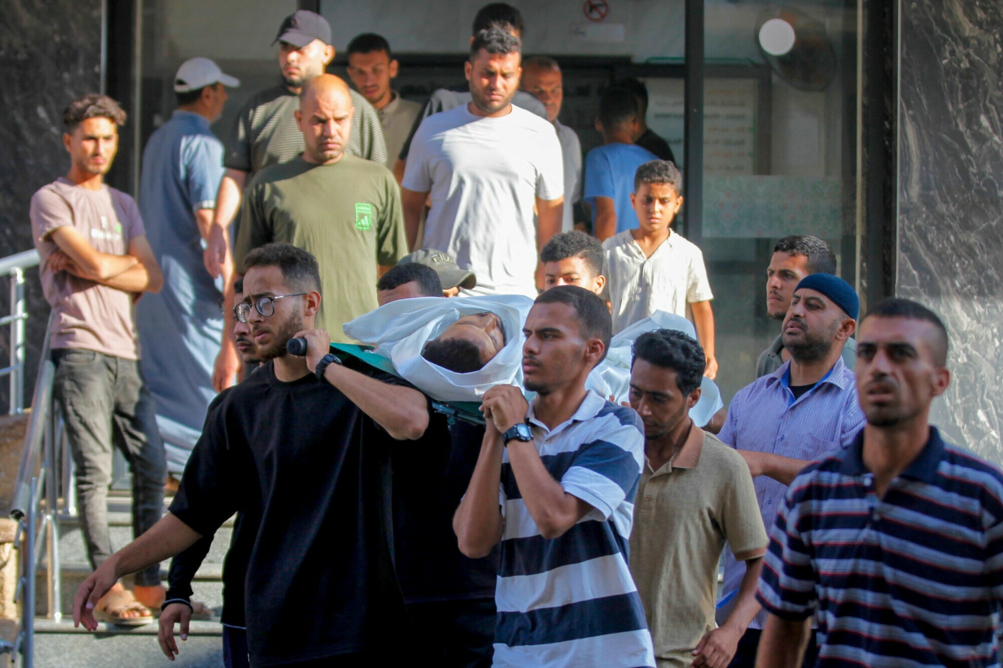Mourners carry a body for burial outside al-Awda hospital in Nuseirat camp in central Gaza, on June 20, 2025, after several Palestinians were killed as they reportedly headed to a food distribution centre. — AFP