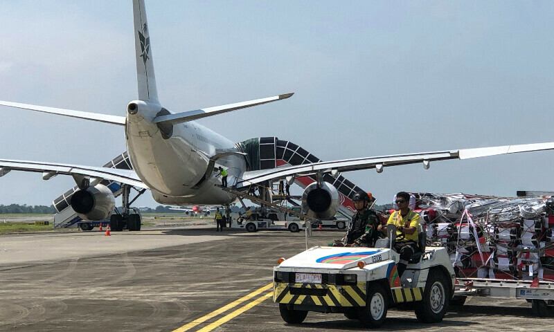 This handout photo taken and released on June 21, 2025 by Indonesian Air Force&rsquo;s Quick Reaction Forces Command (KOPASGAT) shows a military serviceman (front 2nd R) riding on a tug pulling luggage near a Saudia aircraft at the Kualanamu International Airport in Medan, North Sumatra, after the plane was diverted following a bomb threat. &mdash; AFP