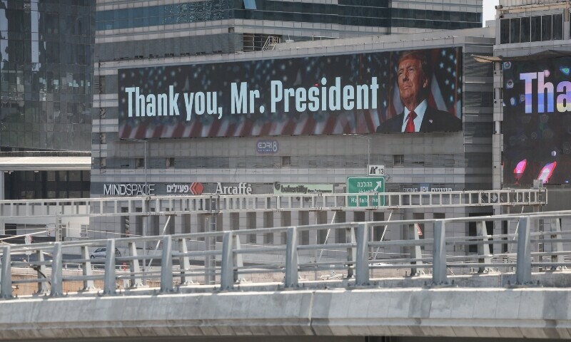 A banner bearing a picture of US President Donald Trump accompanied by a message, is displayed in Tel Aviv on June 22. — AFP