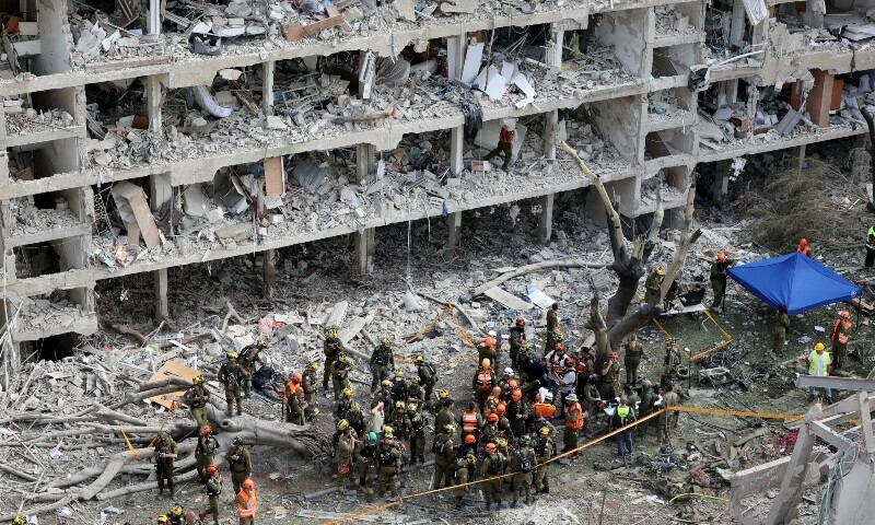 Israeli security forces and first responders gather at the site of an Iranian strike that hit a residential neighbourhood in the Ramat Aviv area in Tel Aviv on June 22. &mdash; AFP