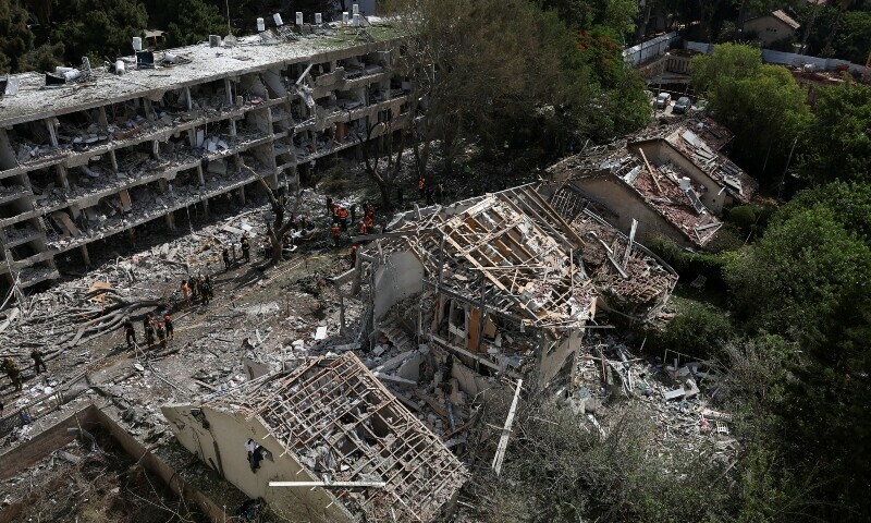 Emergency personnel work at an impact site following a missile attack from Iran on Israel, amid the Iran-Israel conflict, in Tel Aviv, Israel, June 22. &mdash; Reuters
