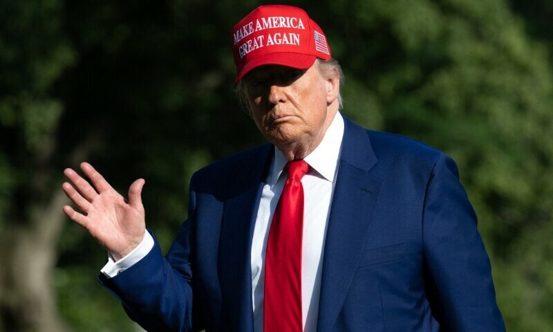 US President Donald Trump walks from Marine One after arriving on the South Lawn of the White House in Washington, DC, on June 21. — AFP
