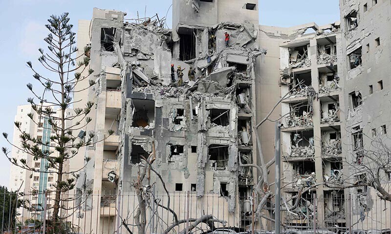 Emergency workers check the damage caused to a building from an Iranian missile strike in Beersheba in southern Israel on June 24. — AFP