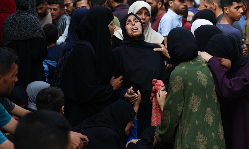 Palestinian women mourn relatives killed a day earlier while attempting to get aid at a distribution point near the Israeli-controlled Zikim border crossing, during a funeral service at Al-Shifa hospital in Gaza City on June 23. &mdash; AFP