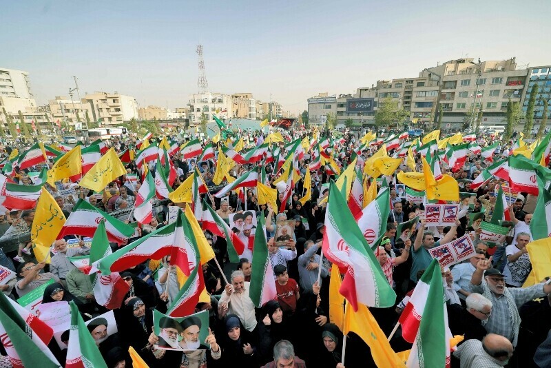 Iranians chant slogans and wave national flags as they celebrate a ceasefire between Iran and Israel at Enghlab Square in the capital Tehran, Iran, June 24. &mdash; AFP