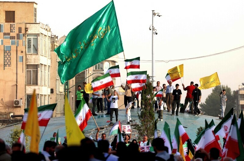 Iranians chant slogans and wave national flags as they celebrate a ceasefire between Iran and Israel at Enghlab Square in the capital Tehran, Iran, June 24. &mdash; AFP