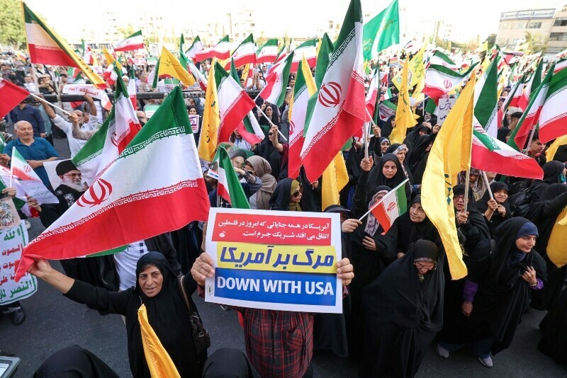 Iranians chant slogans and wave national flags as they celebrate a ceasefire between Iran and Israel at Enghlab Square in the capital Tehran, Iran, June 24. &mdash; AFP