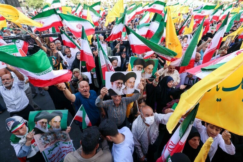 Iranians chant slogans and wave national flags as they celebrate a ceasefire between Iran and Israel at Enghlab Square in the capital Tehran, Iran, June 24. &mdash; AFP