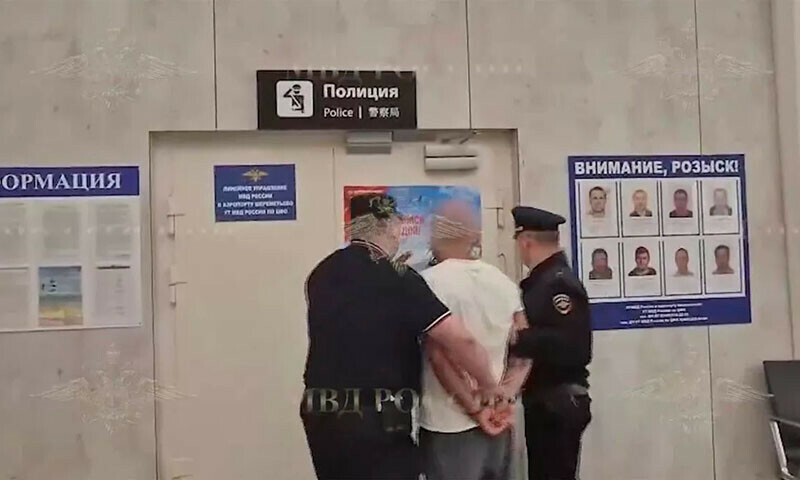 A suspect is led away by police after allegedly attempting to murder a child at Moscow&rsquo;s Sheremetyevo Airport, Russia on June 25. &mdash; Russian Interior Ministry via The Daily Mirror