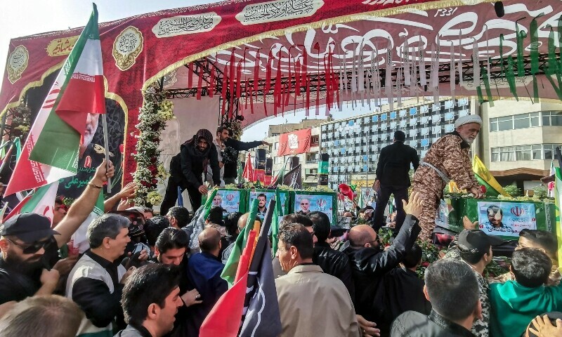  Mourners stand next to the coffin of Iranian Revolutionary Guards commander Hossein Salami (C), and other military commanders and civilians killed during Israeli strikes on the first day of the war, during their funeral procession at Enqelab Square in Tehran on June 28, 2025. — AFP 