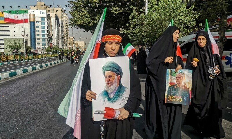  Mourners carry national flags and portraits of Iran’s supreme leader Ayatollah Ali Khamenei (C) and slain Iranian Armed Forces Chief of Staff, Major General Mohammad Bagheri (R), during the funeral procession of military commanders and civilians killed during Israeli strikes on the first day of the war, near Enqelab Square in Tehran on June 28, 2025. — AFP 