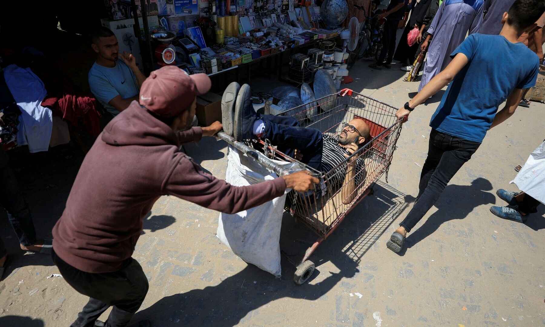 Palestinians move a man injured in an Israeli air strike, in Gaza City, June 29. &mdash; Reuters