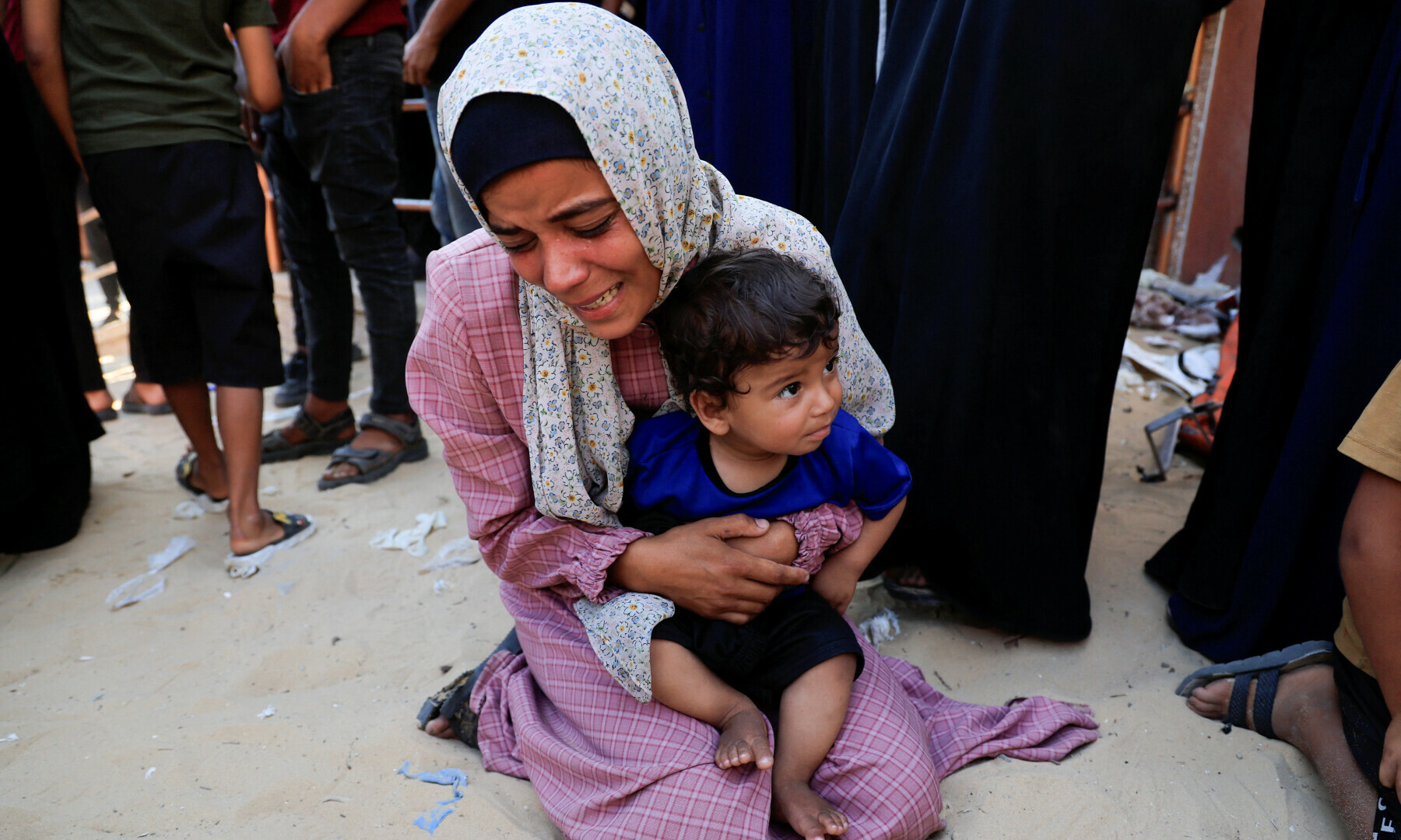 A mourner reacts while holding a child during the funeral of Palestinians killed in an overnight Israeli strike on a tent, according to Gaza&rsquo;s health ministry, at Nasser Hospital in Khan Younis, southern Gaza Strip, June 29. &mdash; Reuters