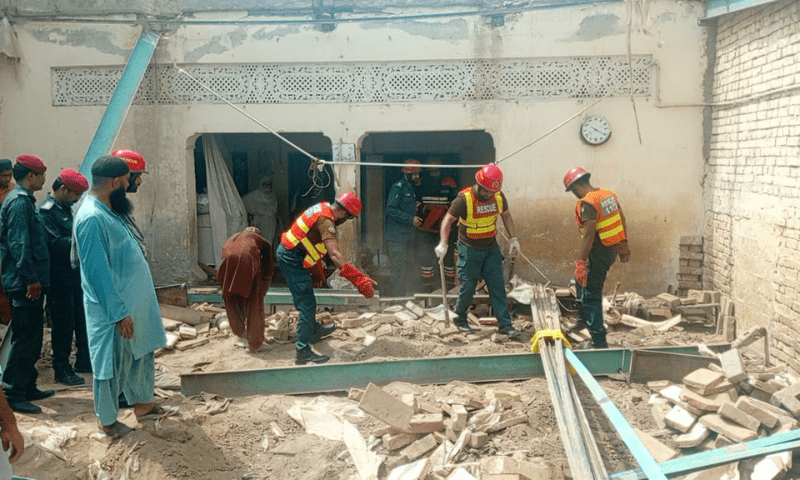Rescue personnel work at the site of a collapsed roof of a madressah in Multan on Monday. &mdash; Photo via Imran Gabol