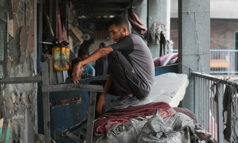 A Palestinian looks on as he sits amidst the damage at an UNRWA school sheltering displaced people that was hit in an Israeli air strike on Sunday, in Gaza City, June 30. — Reuters