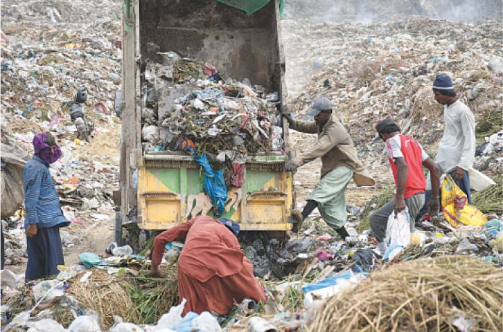 Non-degradable used plastic shopping bags dominate the waste at a garbage dump in the city.—Online