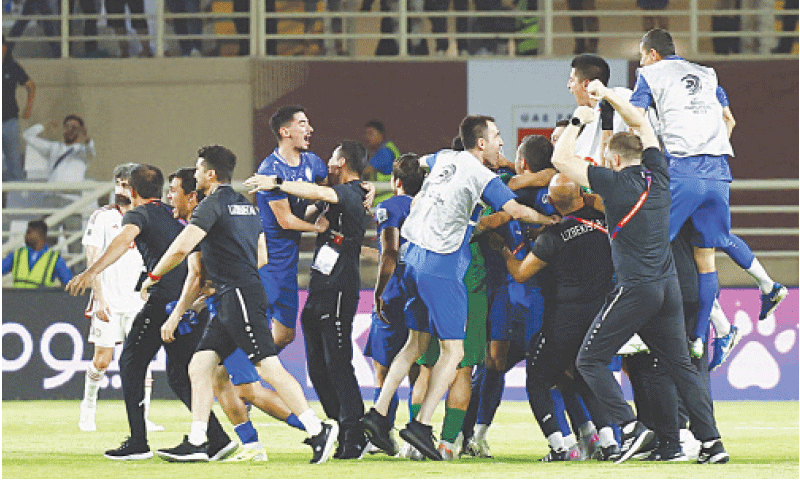 ABU DHABI: Members of Uzbekistan squad celebrate after qualifying for the 2026 World Cup following their draw against the UAE at the Al Nahyan Stadium.
—Reuters