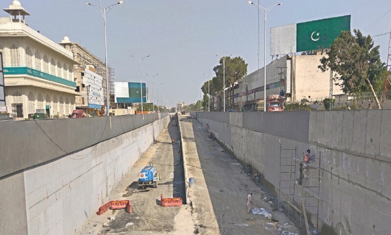 LABOURERS work overtime to complete the GPO underpass project in Rawalpindi before the new deadline of June 30. — Photo by Mohammad Asim