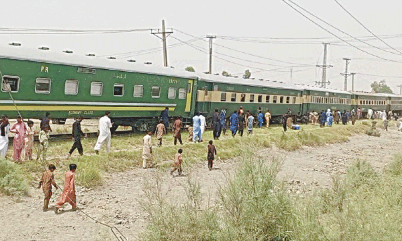 PERTURBED passengers wait for a relief train after the derailment of Khushhal Khan Khattak Express, near Kandhkot on Friday.&mdash;Dawn