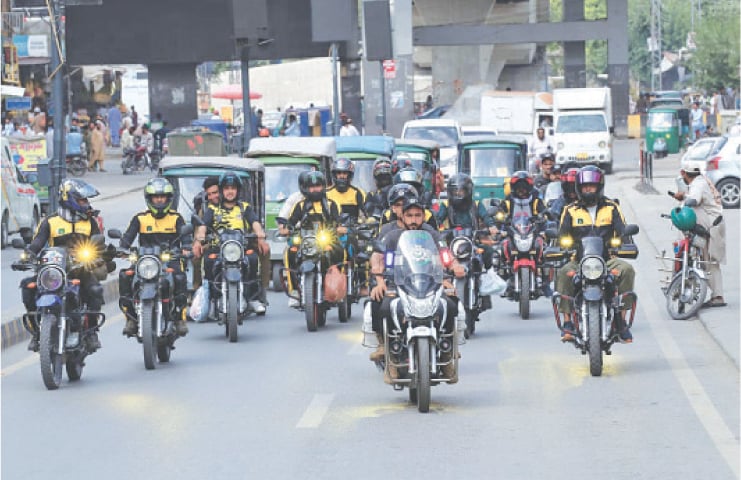 Bikers pass through a road in Peshawar on Friday. &mdash; Dawn