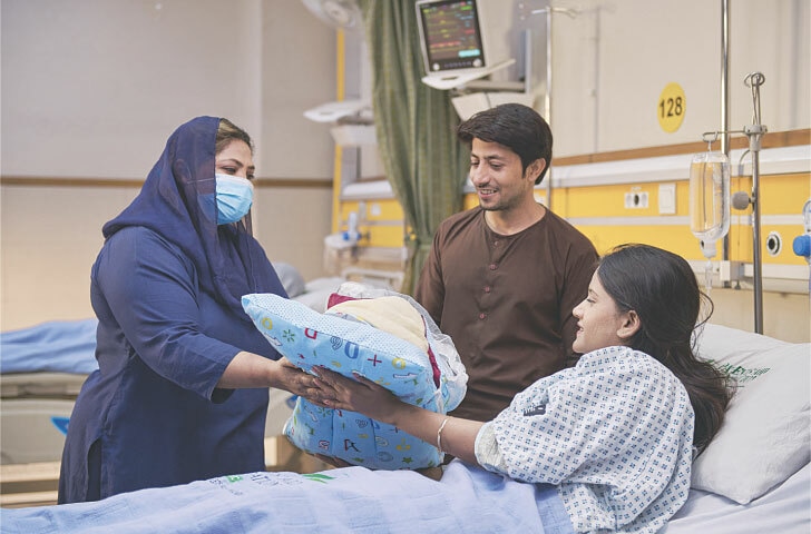 A newborn is handed over to the parents at the gynaecology ward