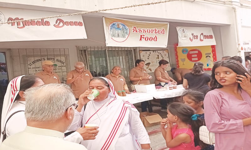 A number of people visit stalls set up for the St Anthony Church’s annual fundraiser despite sweltering weather. — Photo by the writer