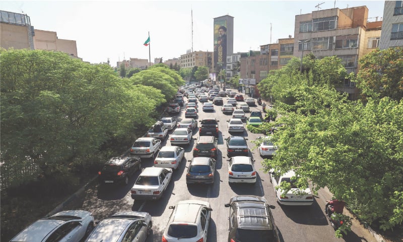Vehicles are stuck in traffic jam at a road in Tehran as people get out of the city on Sunday. Iranian media said an Israeli strike hit the Tehran police headquarters in the city centre, as the two foes exchanged fire for a third day.—AFP