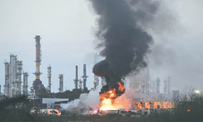 HAIFA: Smoke and flames rise from an Israeli oil facility following a missile attack from Iran.—Reuters