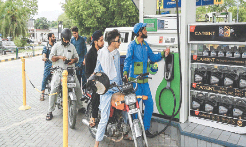 ISLAMABAD: A gas station attendant fills the tank of a motorbike, on Monday. An official announcement said there was no risk of fuel supply disruption.&mdash;AFP