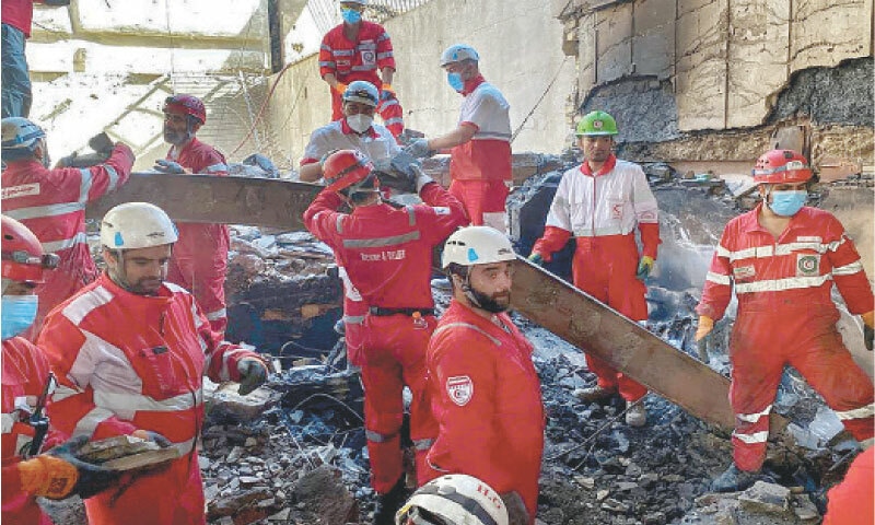 RESCUE personnel search through debris inside a buidling in Tehran which was hit by Israeli strikes on Tuesday.—AFP