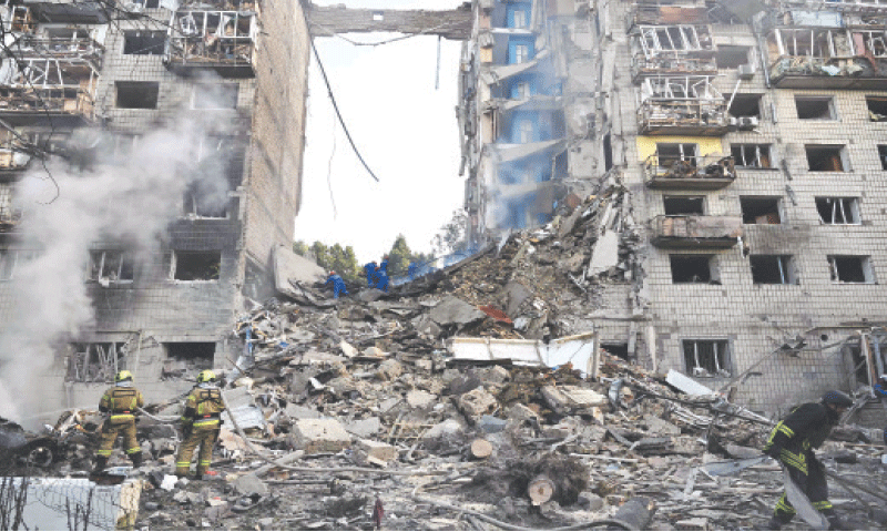 RESCUERS carry out a search in a heavily damaged residential building following the Russian missile strike.—AFP