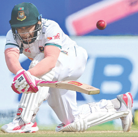 BANGLADESH batter Mushfiqur Rahim plays a sweep shot during the first Test against Sri Lanka at the Galle International Cricket Stadium on Tuesday.—AFP