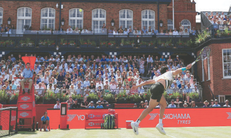 SPAIN’S Carlos Alcaraz jumps to return a shot against Adam Walton of Australia during their Queen’s Club Championships round-of-32 match at the Queen’s Club on Tuesday.—AFP
