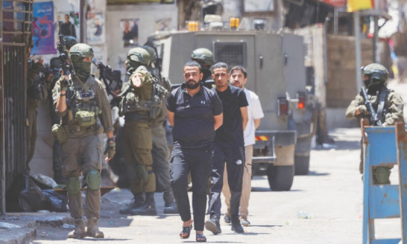 OCCUPIED WEST BANK: Israeli soldiers detain Palestinian men during a raid at the Balata refugee camp, east of Nablus city.—AFP