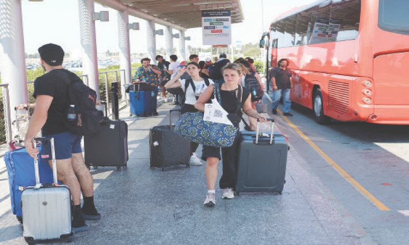 Passengers, who had left Israel a day earlier, aboard the Crown Iris cruise ship, arrive at Larnaca International Airport in Cyprus.—Reuters