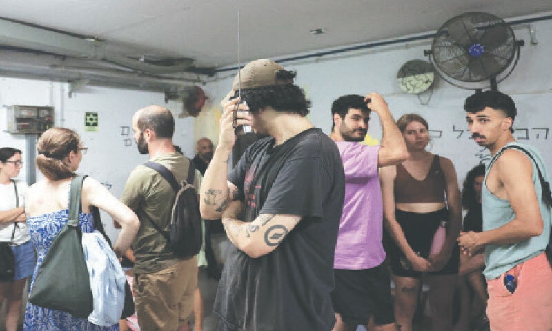 Tel Aviv: People take shelter after a warning about missile launches from Iran.—Reuters
