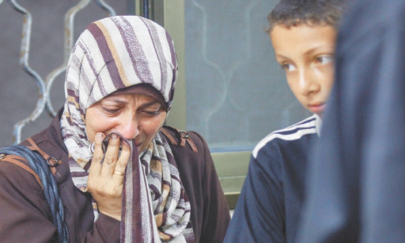A WOMAN cries at the morgue of Al-Awda hospital in Nuseirat camp after several Palestinians were killed by Israel while heading to a food distribution centre in Gaza.—AFP