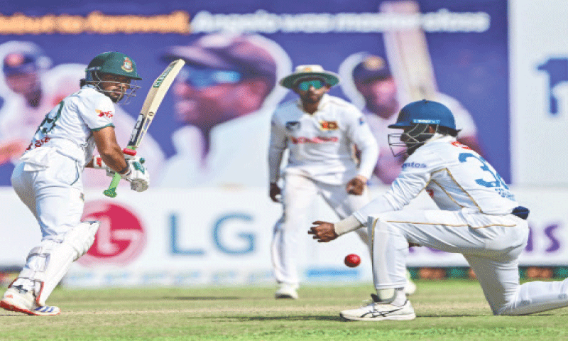 BANGLADESH captain Najmul Hossain watches the ball after playing a stroke during the first Test against Sri Lanka at the Galle International Stadium on Friday.—AFP