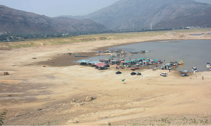 View of the dried-up Khanpur Dam, where water level has fallen drastically. — Online