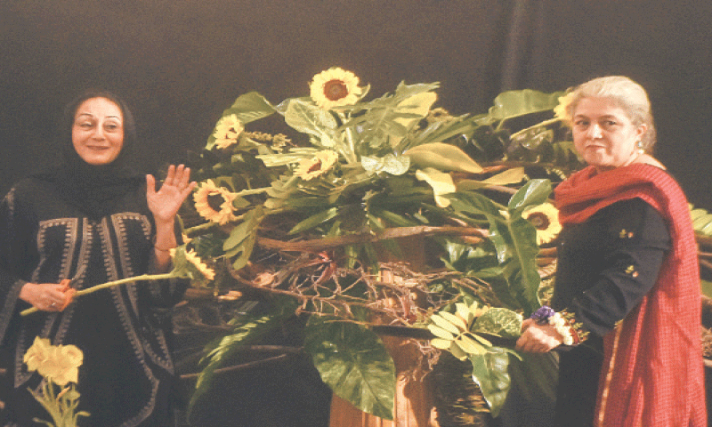 Shaimah Saeed (left) works on the huge sunflowers and heavy foliage central Ikebana piece.—Fahim Siddiqi / White Star
