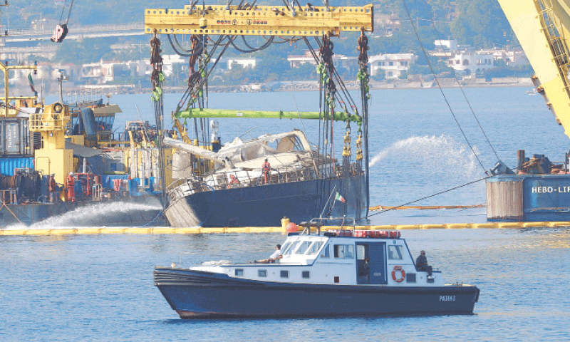 A CRANE ship raises the superyacht that sank off Sicily on Aug 22 last year.—AFP