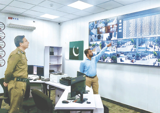 DPO Tariq Aziz Sindhu watches the monitoring screens.