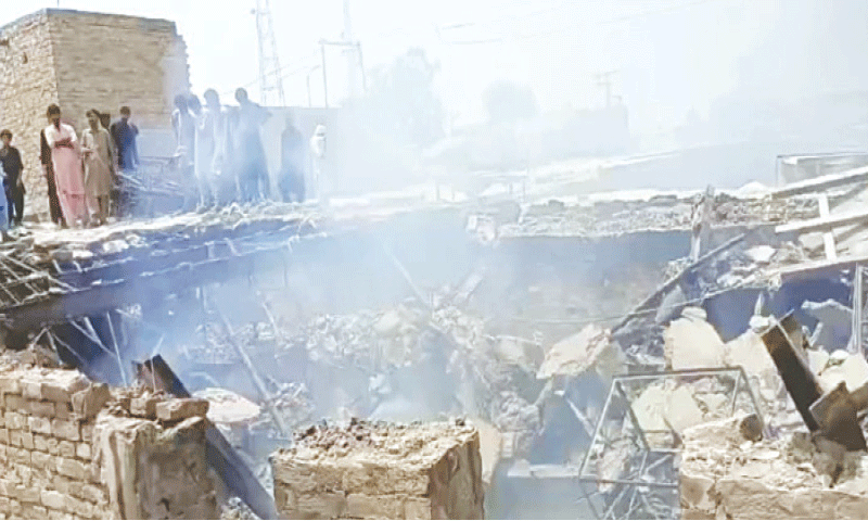 PEOPLE look at the damage caused by the fire.&mdash;Dawn