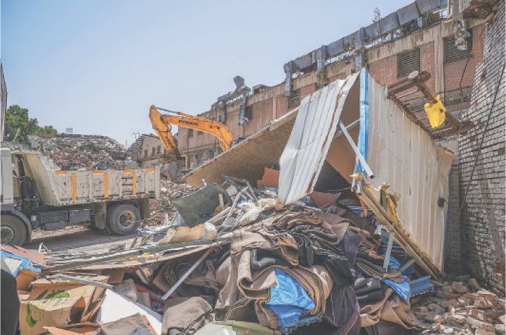  Workers use an excavator to clear the rubble outside Tehran&rsquo;s Evin prison complex, which was hit by an Israeli strike last week.&mdash;AFP 