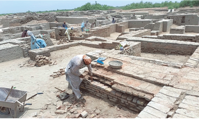 WORKERS repair damaged structures at the archaeological site in Mohenjo Daro.&mdash;Photo by Saeed Memon
