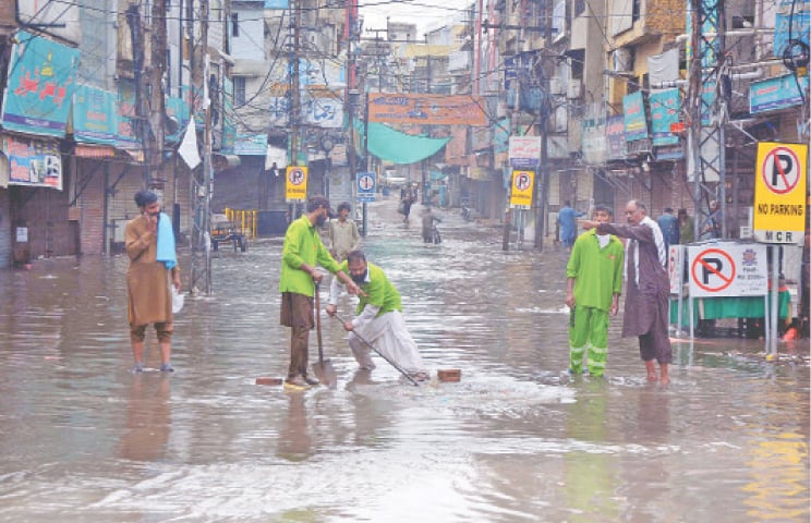 Wasa workers drain out rainwater from Purana Qila Road in Rawalpindi on Thursday. &mdash; Online 