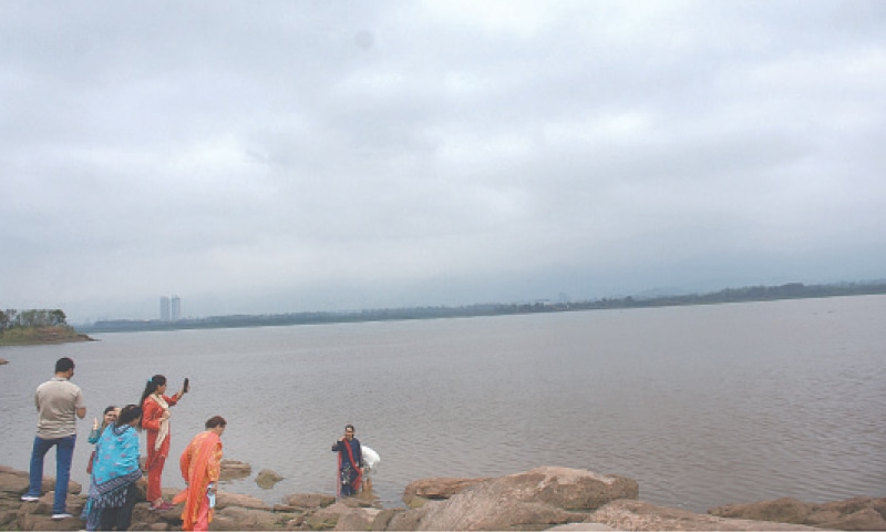 People take selfie at Islamabad&rsquo;s Rawal Dam bank as water level in the lake increased on Thursday. &mdash; Online