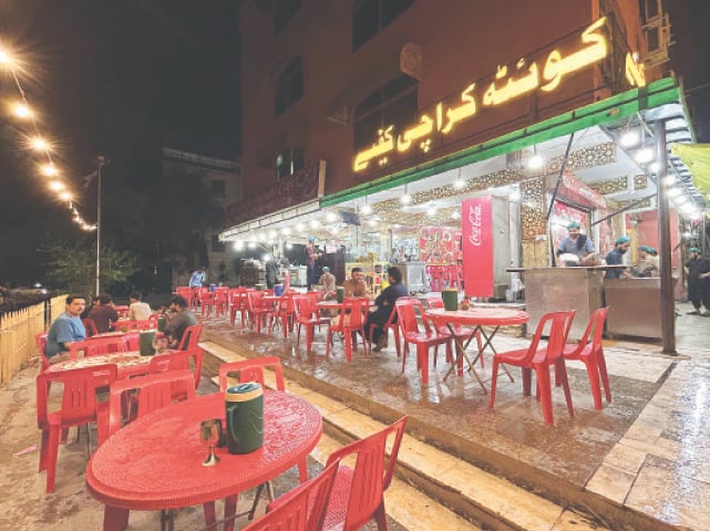 Customers enjoy tea in the open at Quetta Cafe in Aabpara Market. &mdash; Photo by the writer